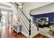 Staircase, hardwood floors, and a glimpse into the living room accent this bright foyer at 10882 Camden Ct, Fishers, IN 46038