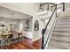 Bright foyer showcasing staircase, hardwood floors, and entry to dining room at 10882 Camden Ct, Fishers, IN 46038