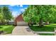 Charming brick home with a well-manicured front yard, two-car garage and a paved driveway at 10882 Camden Ct, Fishers, IN 46038