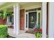 Covered front porch with white columns, decorative plants, and house number at 10882 Camden Ct, Fishers, IN 46038