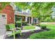 Inviting front yard with a walkway, garden beds, and an Adirondack chair at 10882 Camden Ct, Fishers, IN 46038
