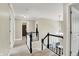 Upstairs hallway featuring hardwood flooring and a view of staircase with black and white railing at 10882 Camden Ct, Fishers, IN 46038