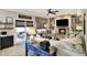 Cozy living room with stone fireplace, built-in shelves, and ample seating at 10882 Camden Ct, Fishers, IN 46038