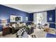 Comfortable living room with stylish furniture, a decorative mirror, and blue accent wall at 10882 Camden Ct, Fishers, IN 46038