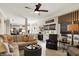 Cozy living room with an L-shaped sectional sofa and view of the kitchen at 10882 Camden Ct, Fishers, IN 46038
