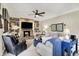 Comfortable living room with a stone fireplace, built-in shelves and ample seating at 10882 Camden Ct, Fishers, IN 46038
