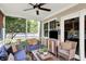 Relaxing screened-in porch with ceiling fan and a view of the beautifully landscaped yard at 10882 Camden Ct, Fishers, IN 46038