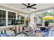 A comfortable screened in porch with ceiling fan and a view of the backyard at 10882 Camden Ct, Fishers, IN 46038