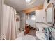 Well-lit bathroom featuring a tub-shower combo, wood accents, and a vanity with ample storage at 109 N Avon Ave, Avon, IN 46123