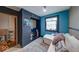 Brightly colored bedroom with a window, sofa, and built-in storage shelving at 109 N Avon Ave, Avon, IN 46123