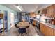 Cozy kitchen featuring wood cabinetry, modern appliances, and a dining area with comfortable seating at 109 N Avon Ave, Avon, IN 46123