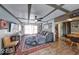 Warm living area featuring decorative ceiling beams, wood flooring, comfortable seating, and stylish accents at 109 N Avon Ave, Avon, IN 46123