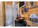 Bathroom with a stand-up shower, vanity with vessel sink, and exposed plumbing and water heater at 10935 Cornell St, Carmel, IN 46280