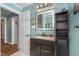 Well-lit bathroom featuring granite counters, a dark wood vanity, and a backlit mirror at 10935 Cornell St, Carmel, IN 46280