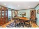 Traditional dining room featuring a wooden table, ornate china cabinet, and an eye-catching patterned rug at 10935 Cornell St, Carmel, IN 46280