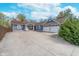 Charming blue home with a spacious driveway and a two-car garage, perfect for a growing Gathering at 10935 Cornell St, Carmel, IN 46280