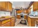 Updated kitchen featuring stainless steel appliances, wood cabinets, and a decorative ceiling light at 10935 Cornell St, Carmel, IN 46280