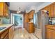 Updated kitchen featuring stainless steel appliances, wooden cabinets, and a view of the adjacent living area at 10935 Cornell St, Carmel, IN 46280