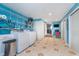 Functional laundry room with washer, dryer, shelving and access to another room at 10935 Cornell St, Carmel, IN 46280