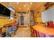 Cozy living area featuring wooden walls and ceiling, a dining table, massage table, and sauna at 10935 Cornell St, Carmel, IN 46280