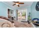 Inviting living room featuring a massage chair, sliding door to backyard and light blue walls at 10935 Cornell St, Carmel, IN 46280