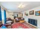 Cozy living room featuring a fireplace, plush leather seating, and decorative rug at 10935 Cornell St, Carmel, IN 46280