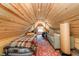 Finished loft space with exposed beams, bed, sofa, and carpeted floor at 10935 Cornell St, Carmel, IN 46280