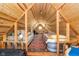 Finished loft space with exposed beams, bed, sofa, and carpeted floor at 10935 Cornell St, Carmel, IN 46280