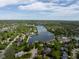 Aerial view of the community surrounding a serene lake, showcasing the property's desirable location and scenic views at 11780 Pebblepointe Pass, Carmel, IN 46033