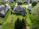 Aerial view showcasing the property's large backyard, lush landscaping, and inviting back porch, ideal for outdoor living at 11780 Pebblepointe Pass, Carmel, IN 46033