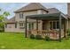 Spacious backyard featuring a well-manicured lawn and a large back porch with a pergola perfect for outdoor relaxation at 11780 Pebblepointe Pass, Carmel, IN 46033