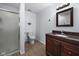 Cozy bathroom featuring a shower with glass door, a modern vanity, and tile flooring, perfect for daily routines at 11780 Pebblepointe Pass, Carmel, IN 46033