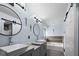 Spa-like bathroom with double vanity, soaking tub, and stylish mirrors at 11780 Pebblepointe Pass, Carmel, IN 46033