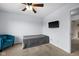 Bedroom features a comfy armchair, neutral tones, and ample natural light at 11780 Pebblepointe Pass, Carmel, IN 46033