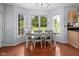 Cozy dining area with hardwood floors, a large window, and natural light at 11780 Pebblepointe Pass, Carmel, IN 46033