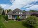 Beautiful home with a large front yard and a blue front door at 11780 Pebblepointe Pass, Carmel, IN 46033