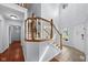Bright foyer featuring a staircase with wood railing and a view to the outside at 11780 Pebblepointe Pass, Carmel, IN 46033