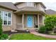 Charming front entrance with a decorative blue door and well-manicured landscaping at 11780 Pebblepointe Pass, Carmel, IN 46033