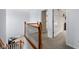 Second floor staircase landing showcasing wood banister and carpeted floors at 11780 Pebblepointe Pass, Carmel, IN 46033