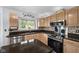 A well-equipped kitchen featuring stainless steel appliances and a tile backsplash at 11780 Pebblepointe Pass, Carmel, IN 46033