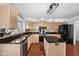 Well-lit kitchen with stainless steel appliances, granite countertops, and stylish backsplash at 11780 Pebblepointe Pass, Carmel, IN 46033
