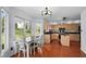 Bright eat-in kitchen with wood cabinets, stainless appliances, and hardwood floors at 11780 Pebblepointe Pass, Carmel, IN 46033