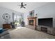 Comfortable living room with a fireplace, large windows, and plush seating at 11780 Pebblepointe Pass, Carmel, IN 46033