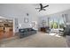Spacious living room with a staircase, fireplace, and large windows at 11780 Pebblepointe Pass, Carmel, IN 46033