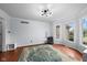 Bright living room with hardwood floors, large windows and a modern light fixture at 11780 Pebblepointe Pass, Carmel, IN 46033