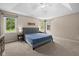 Bright main bedroom showcasing a tray ceiling, plush carpet, and multiple windows at 11780 Pebblepointe Pass, Carmel, IN 46033
