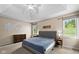 Primary bedroom featuring tray ceiling, plush carpet, multiple windows and ensuite bath at 11780 Pebblepointe Pass, Carmel, IN 46033