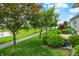 Lush backyard with manicured landscaping, a tranquil pond, and a walking path for nature enjoyment at 127 Coatsville Dr, Westfield, IN 46074