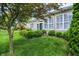 Landscaped backyard with mature trees, green lawns, and a charming patio area, creating a private oasis at 127 Coatsville Dr, Westfield, IN 46074