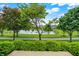 Scenic backyard with manicured landscaping, a peaceful pond, and walking path for outdoor relaxation at 127 Coatsville Dr, Westfield, IN 46074